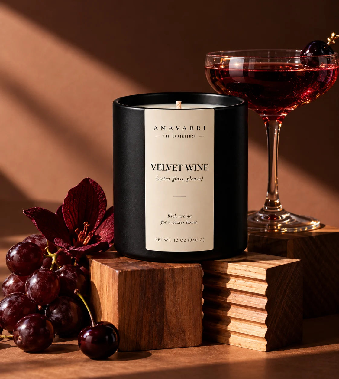 Velvet Wine candle styled with a glass of red wine, dark grapes and cherries